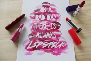 lipstick writing a message on a white paper